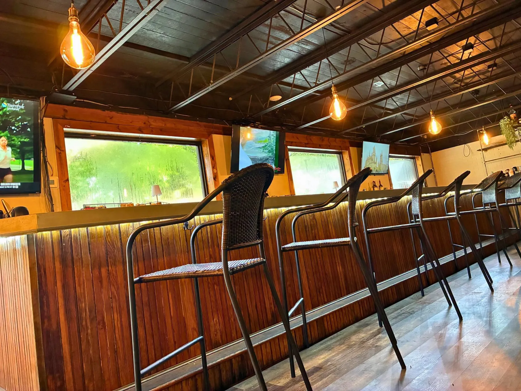 The bar inside Lazy Oak with wood counter and stools