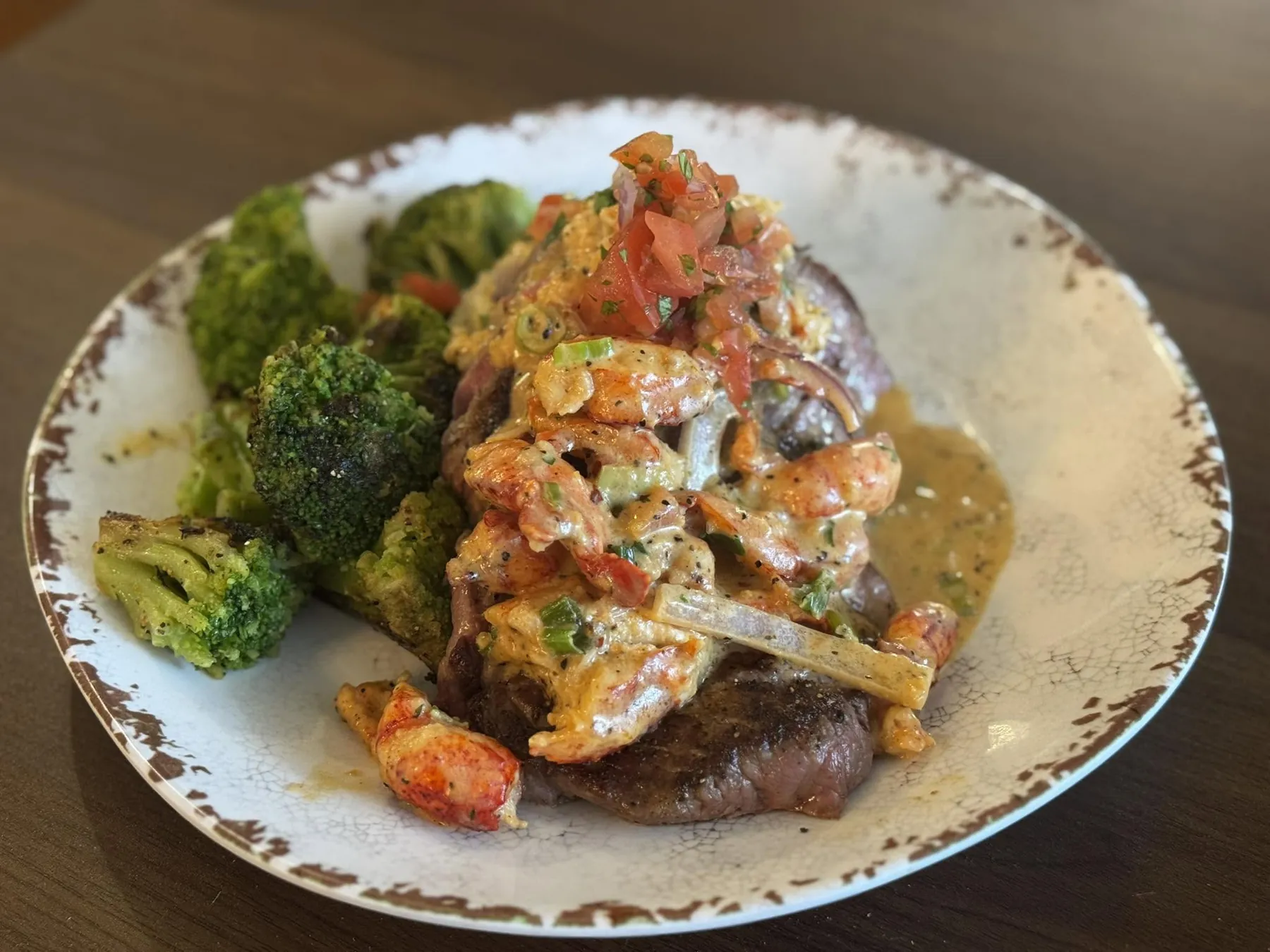 Steak topped with crawfish cream sauce and broccoli