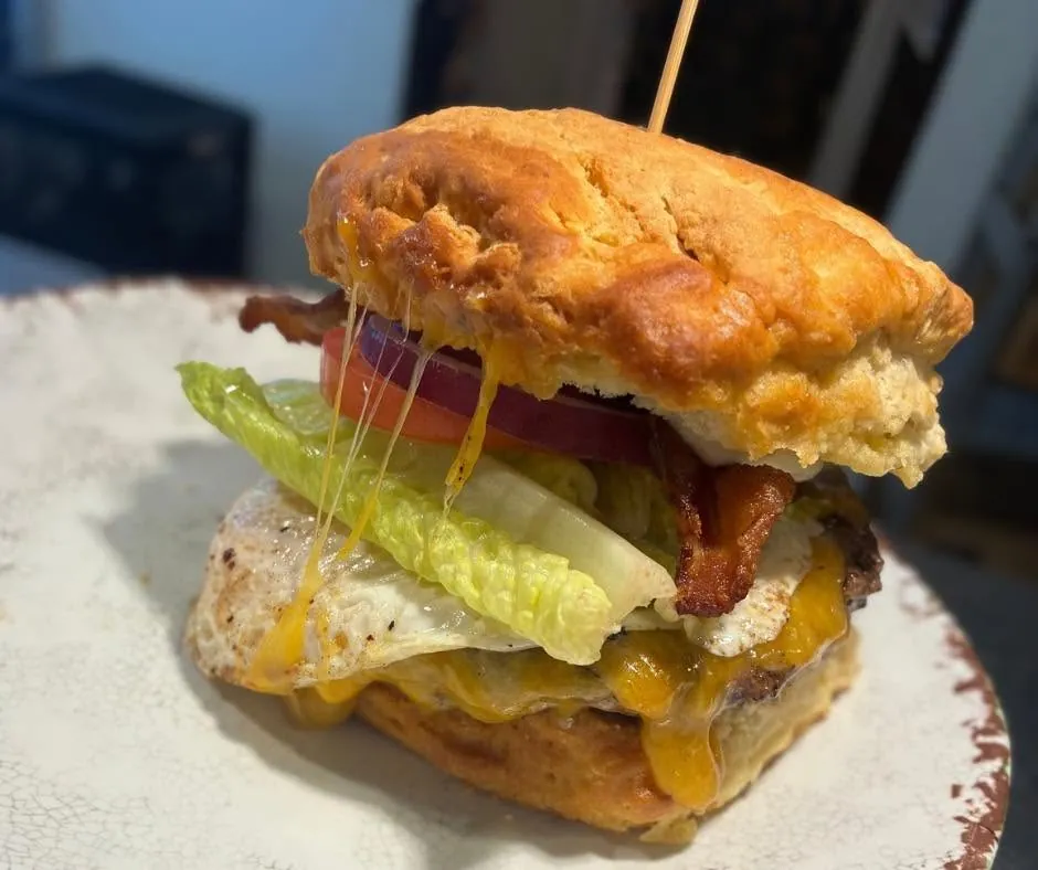 Biscuit sandwich with egg, bacon and melted cheese
