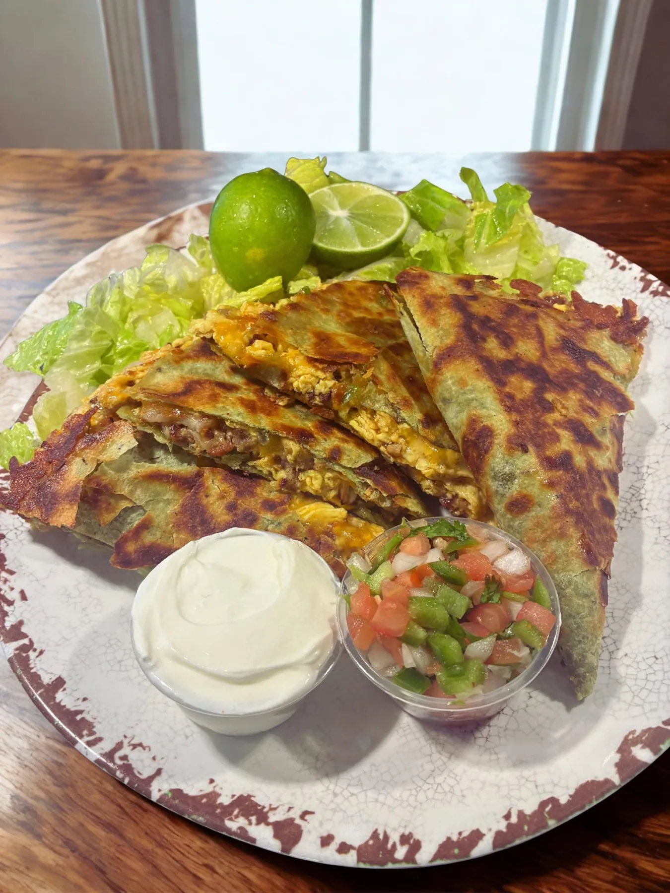 Loaded breakfast quesadilla with sour cream and pico